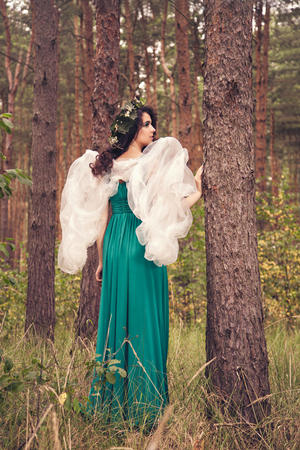 Beautiful brunette girl with white wingsの写真素材