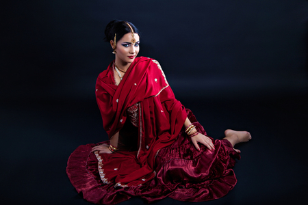 Beautiful young indian woman in traditional clothing and indian accessoriesの写真素材