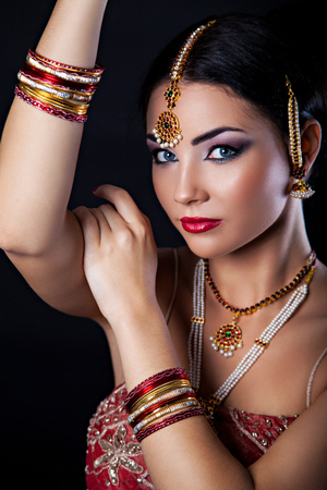 Beautiful girl with oriental makeup and Indian Jewelry, fashion lookの写真素材