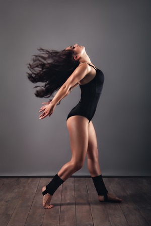 Modern style beautiful dancer posing on studio backgroundの写真素材