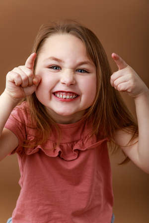 Studio portrait of funny smiling preschool girlの写真素材