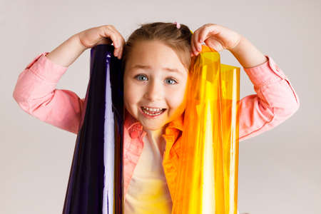 Preschool girl learning colors and their combinations using colored foil, early development and learning concept.の写真素材