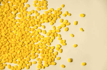 Scatter yellow bean on white paperの写真素材