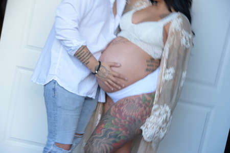 pregnant couple wearing white clothesの写真素材