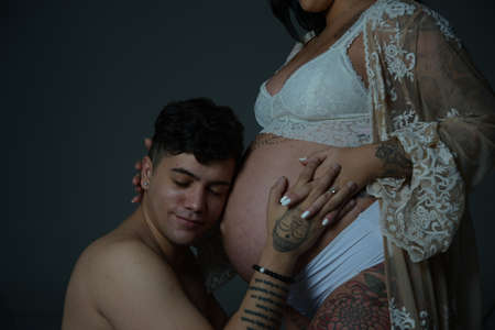 Pregnant wife wearing white clothesの写真素材