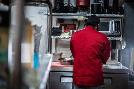 Chef preparing cooking and serving indian cuisine style dishの写真素材