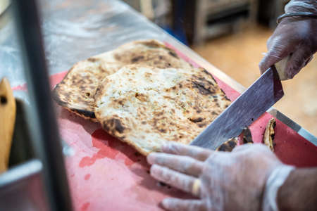 Chef preparing cooking and serving indian cuisine style dishの写真素材
