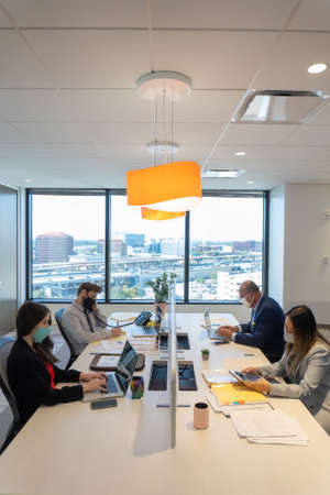 Office employee having a meeting with their teamの写真素材