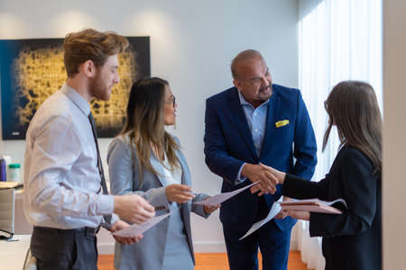 Office employee having a meeting with their team