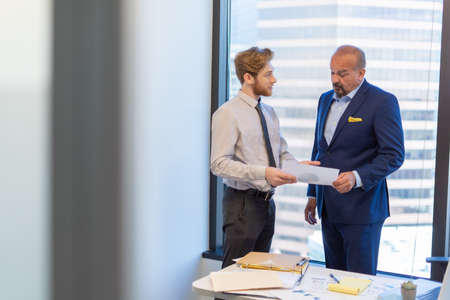 Office employee having a meeting with their team