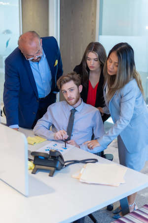 Office employee having a meeting with their team