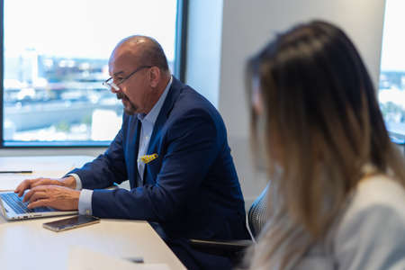 Office employee having a meeting with their team