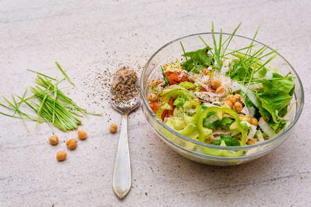Green wheat and mixed salad with chickpeas in a bowl. Homemade healthy food  lots of seasoningsの写真素材
