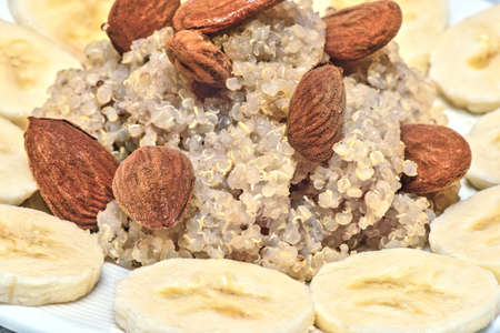 Quinoa served with banana, almonds and honey. Fresh morning breakfastの写真素材