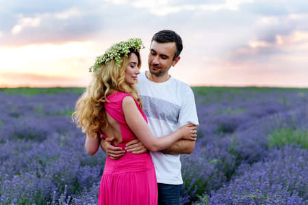 Happy Couple in the middle of lavender field. Romantic view at sunsetの写真素材