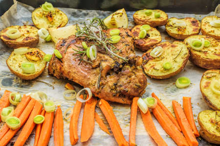 Roasted garlic and lemon turkey with vegetables and rosemary. Homemade dinnerの写真素材