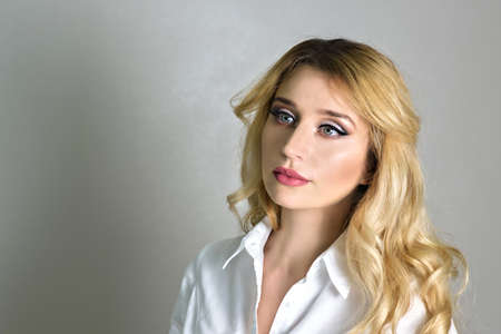 Beautiful Fashion Luxury Makeup, long eyelashes, perfect skin facial make-up. Beauty Blonde model woman, Blue eyes make up close up. Mat lipsの写真素材