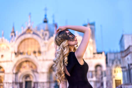 Girl wearing a black mask in San Marco Square, Italyの写真素材