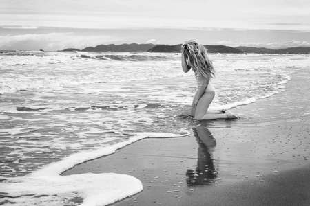 Sad Woman crying portrait at Forte dei Marmi beach, Italy. Liguria Beautiful Seaside backgrounds. Black and whiteの写真素材