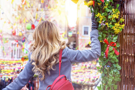 Woman at Easter market in Prague, Czeh Republic. Easter holiday decors
