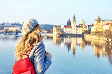Tourist girl dicovering Prague, Czeh Republic. Charles bridge view on background. Beauty city scapeの写真素材