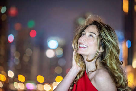 Woman in Dubai Marina, United Arab Emirates. Attractive girl admiring Marina view at nights