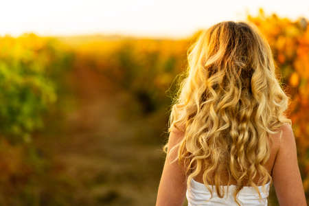 Vintage portrait woman in the vineyard. Autumn backgroundの写真素材