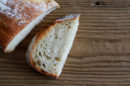 Bread slice and Bread loaf on wooden tableの写真素材