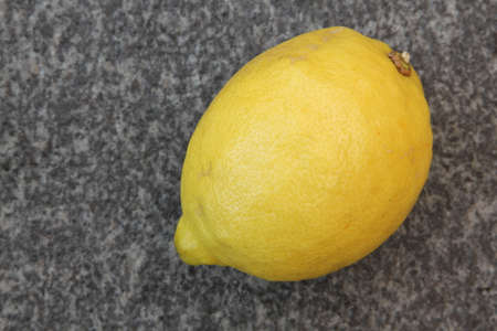 Lemon isolated on stone backgroundの写真素材