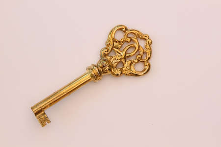 Metal key in vintage look on white backgroundの写真素材
