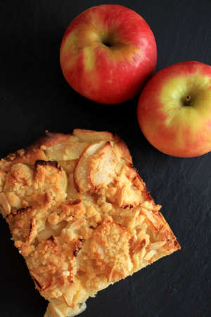 Fresh homemade apple pie with apple, black background, top view