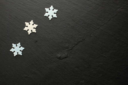 White and blue sugar snowflakes on black backgroundの写真素材