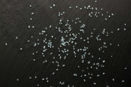 Blue sugar crystals on black backgroundの写真素材