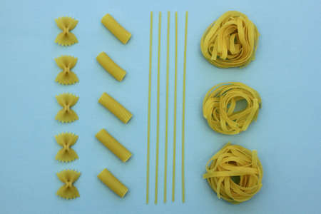 Raw pasta food knolling concept on blue boardの写真素材