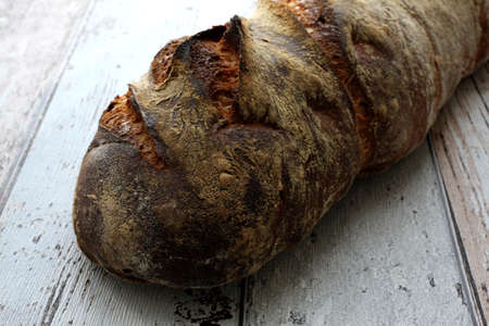 Fresh and crusty bread on rustic table