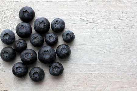 Blueberries on white shabby looking tableの写真素材