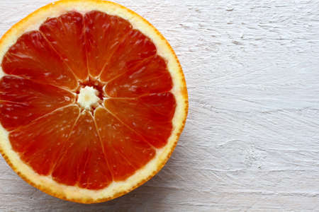 Half blood orange on shabby looking white boardの写真素材