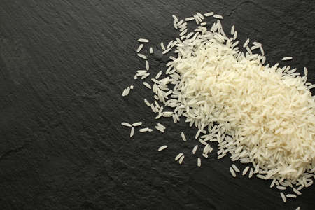Raw jasmine rice on slate board, top view, copy spaceの写真素材