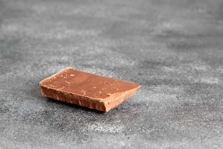 Dark bitter chocolate on a dark board, selective focus
