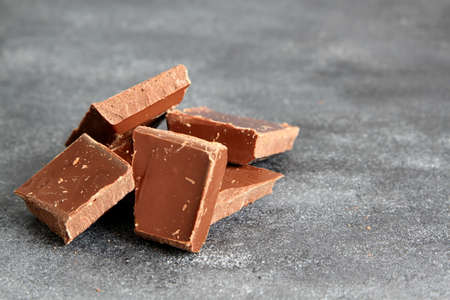 Dark bitter chocolate on a dark board, selective focus
