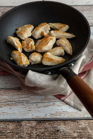 Roasted chicken breast in antique looking frying panの写真素材