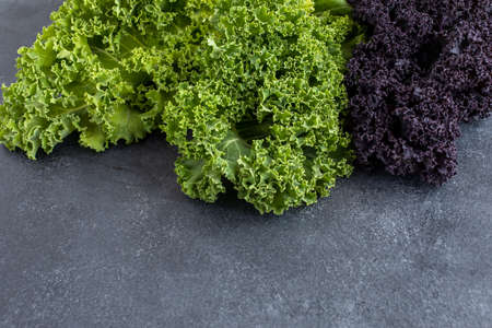 Colorful spring cabbage on dark board, high angle view, closeupの写真素材