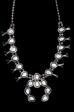 Silver squash blossom navajo necklace with opal gems on black backgroundの写真素材