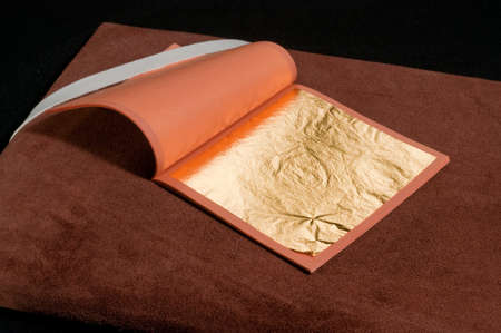 a booklet of pure gold leaf for gilding with craftsman's toolsの写真素材
