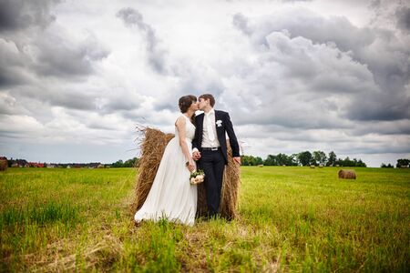 Bride and groom near hay in your wedding dayの写真素材