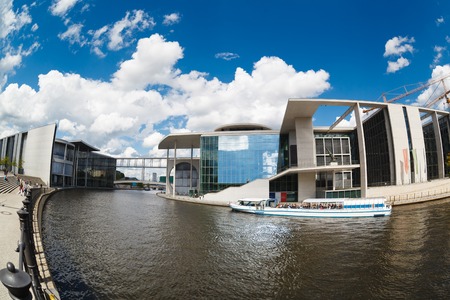 Berlin, Germany, May 12 2013: Tourists ship float on the river Spree next to a modern buildings of Bundestag and Marie-Luders-Hausのeditorial素材