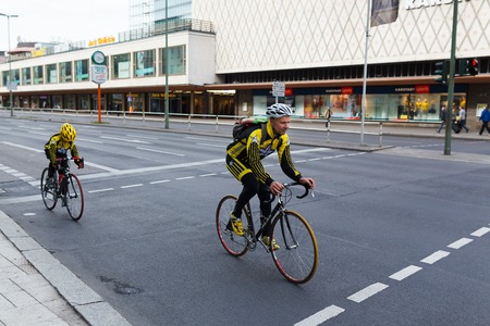 Berlin, Germany, May 12 2013: Cyclists father and son riding bicycles along the Joachimstaler streetのeditorial素材