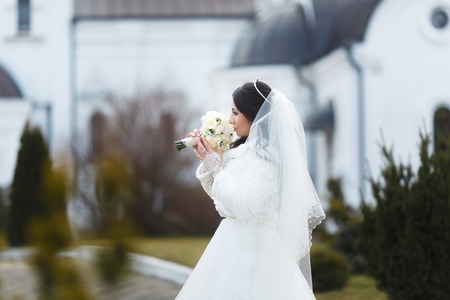 Portrait of a sensual bride on the church backgroundの写真素材