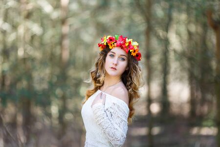 Portrait of a beautiful girl with flowers in her hair at spring timeの写真素材