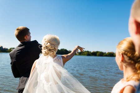 Ceremony of throw the key by a river on the wedding dayの写真素材
